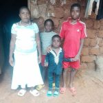 Mrs. Elise and her children receiving help
