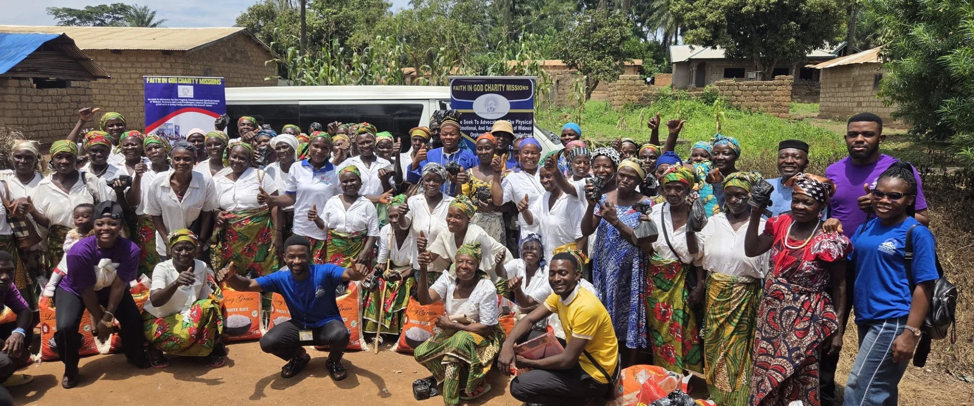 Community members gathered outdoors with supplies at an FIGCM livelihood distribution.
