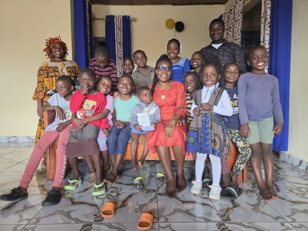 Children and carers gathered on the veranda at the FIGCM orphanage.
